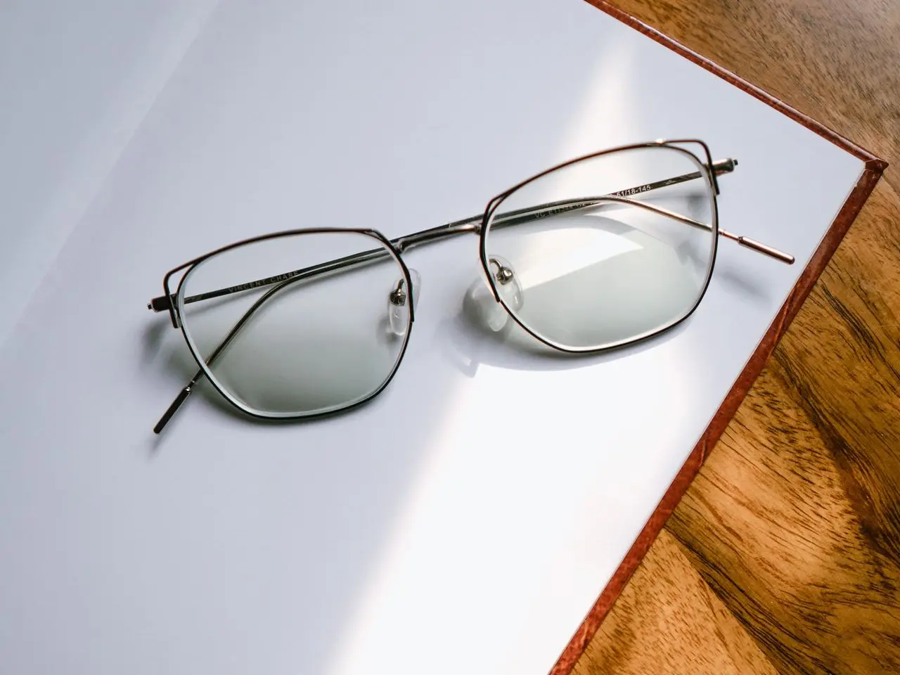 black framed eyeglasses on white table
